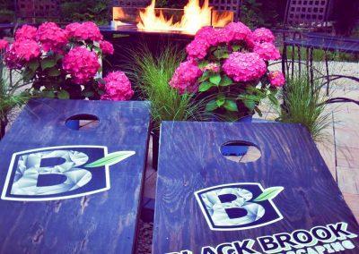 Wooden signs bearing the logo of Black Brook Lawn & Landscaping