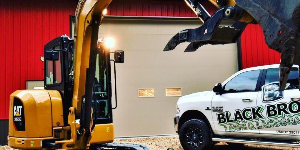 A Black Brook work truck parked outside of a commercial building.