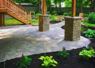 A newly built walkout paver patio constructed by Black Brook Lawn & Landscaping