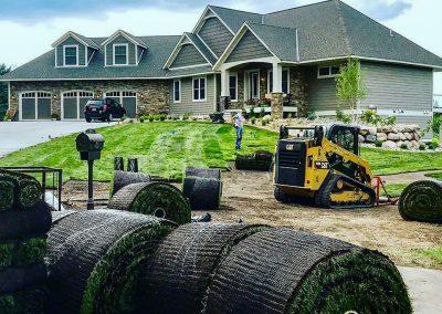 A Black Brook employee laying sod in a client's lawn
