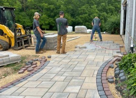 Black Brook employees building a paver driveway.