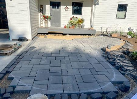 A paver patio using concrete stone that was recently constructed by Black Brook Lawn & Landscaping.