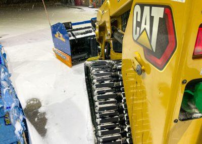 A close up of snow covering Black Brook's landscaping equipment