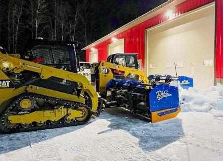 Black Brook's fleet of snow clearing vehicles sitting in a snowy lot before it is cleared.