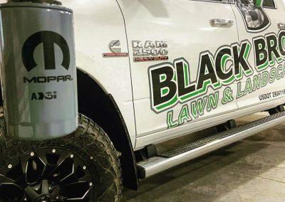 A Black Brook Lawn and Landscape work truck bearing the logo of the company